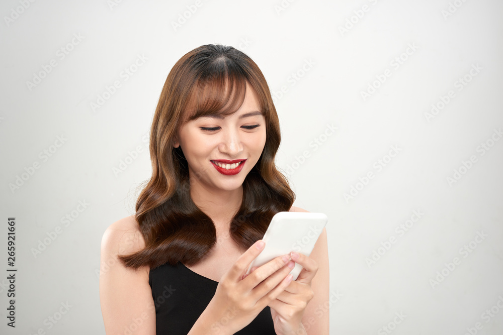 Portrait of a happy asian businesswoman using mobile phone isolated over white background Portrait of a happy asian businesswoman using mobile phone isolated over white background