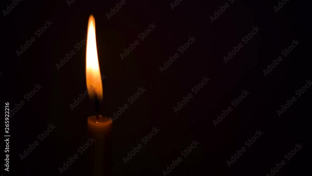 Close-up of candle flame in black background. Close-up of candle flame in black background.