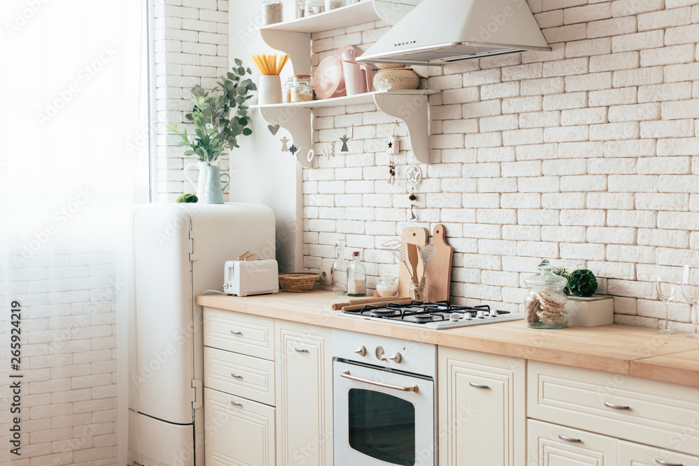 Fototapeta premium cozy modern kitchen with cooking utensils and plants