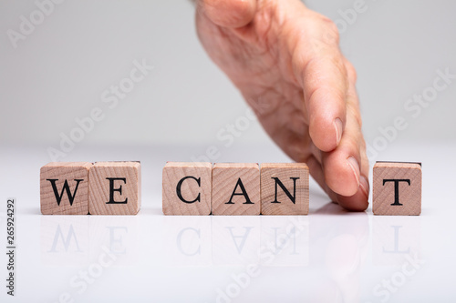 Person's Hand Separating 't' From The We Can Blocks