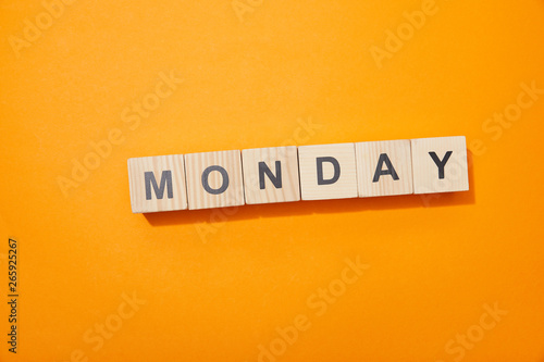 top view of wooden blocks with letters on orange surface