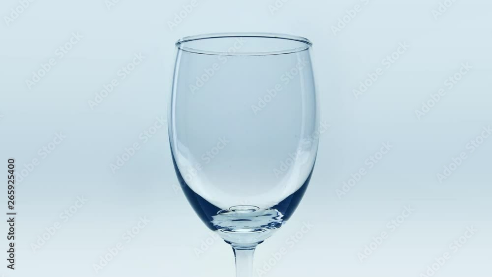 Pouring soda water into a clear glass. Pouring soda water into a clear glass.