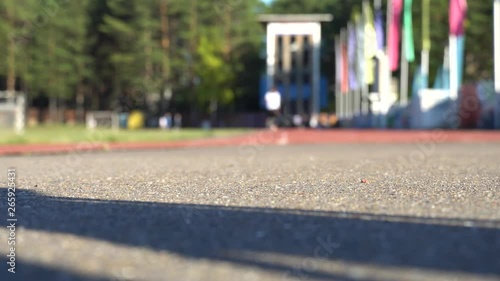 Blurred background of runners on provincial stadium. Amateur sport footage 4k