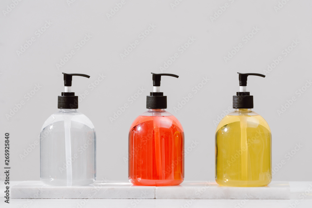 Cosmetic bottles with shower gel, body lotion or shampoo and bath towels. Bathroom accessories. Cosmetic bottles with shower gel, body lotion or shampoo and bath towels. Bathroom accessories.