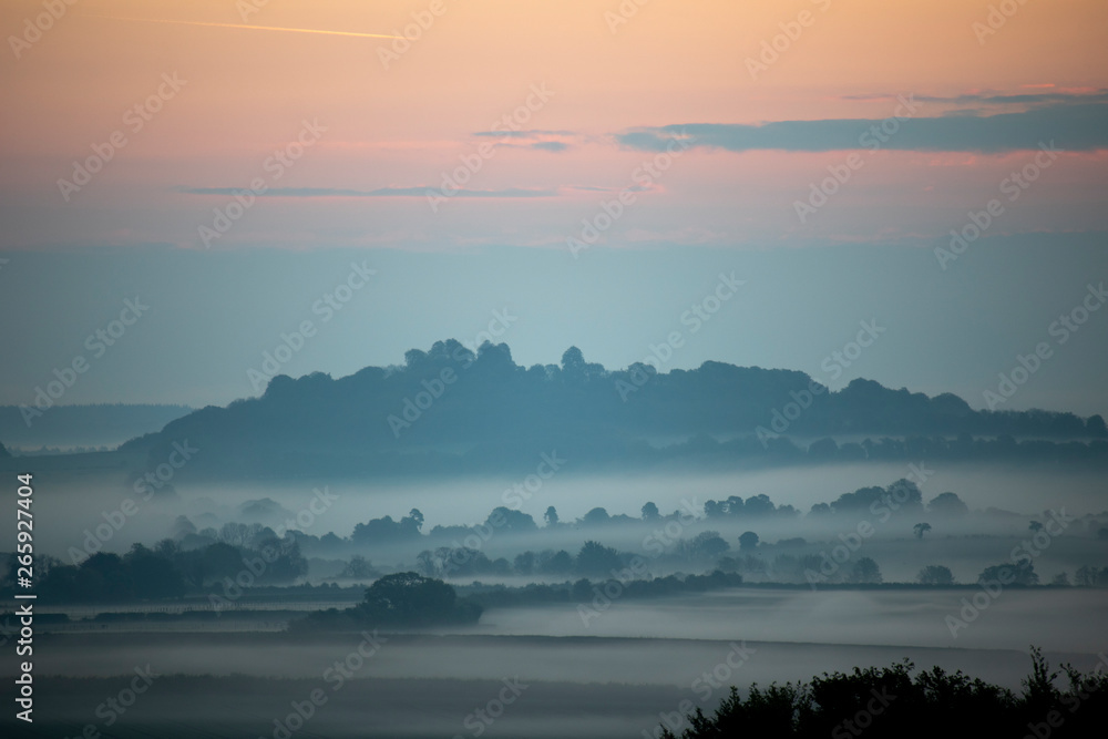Early morning mist over farmland and woodland in rural Hampshire