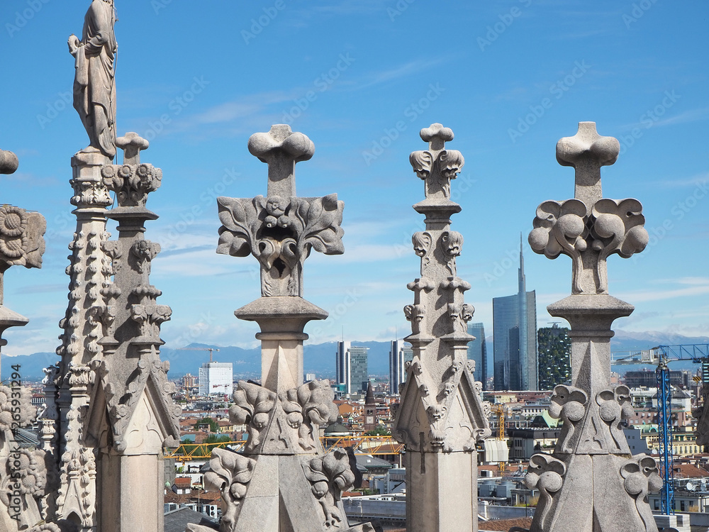 Obraz premium Milano, Italy. Panorama of the city and the skyscraper from the roof terrace of the cathedral. The white marble spires of the Duomo