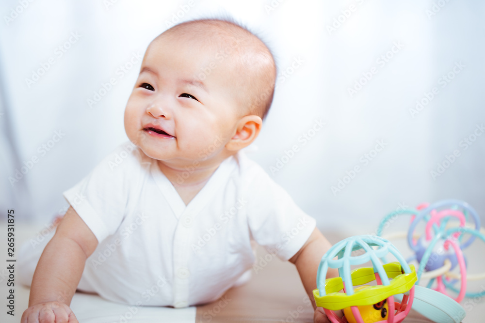 Asian baby happy in the room.Asian baby girl lying down on bed . Asian baby happy in the room.Asian baby girl lying down on bed .