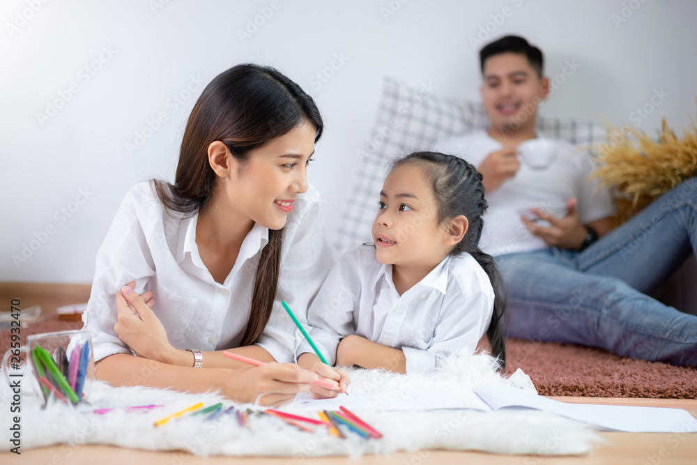 Young family drawing together with colorful pencils at home Young family drawing together with colorful pencils at home