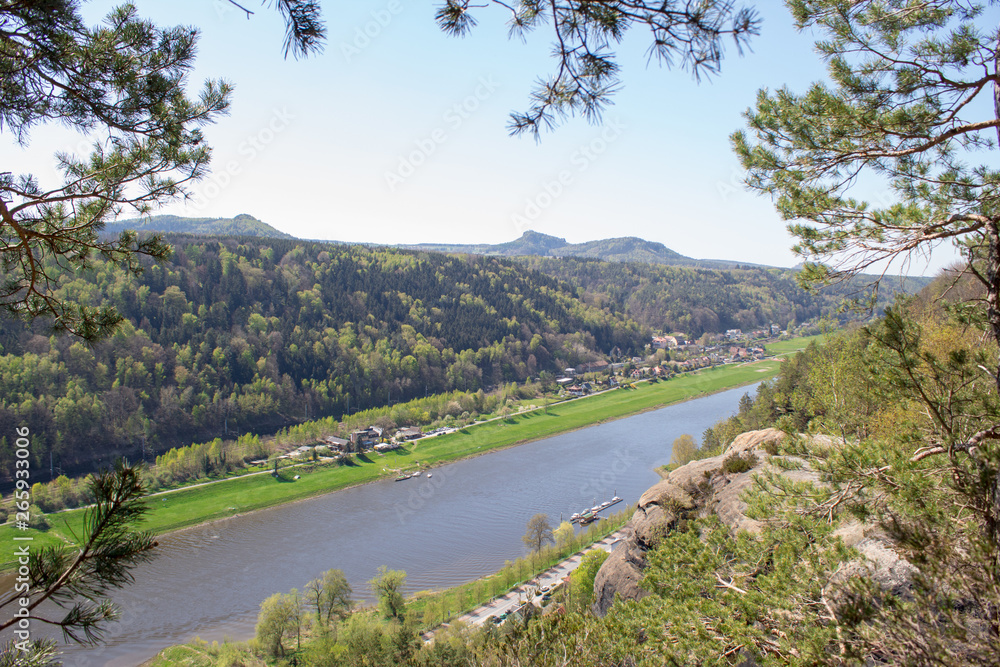 Saxon Switzerland - Germany main attraction. View from Bastei in view of a German town, sandy cliffs and the river Elbe on a sunny spring day