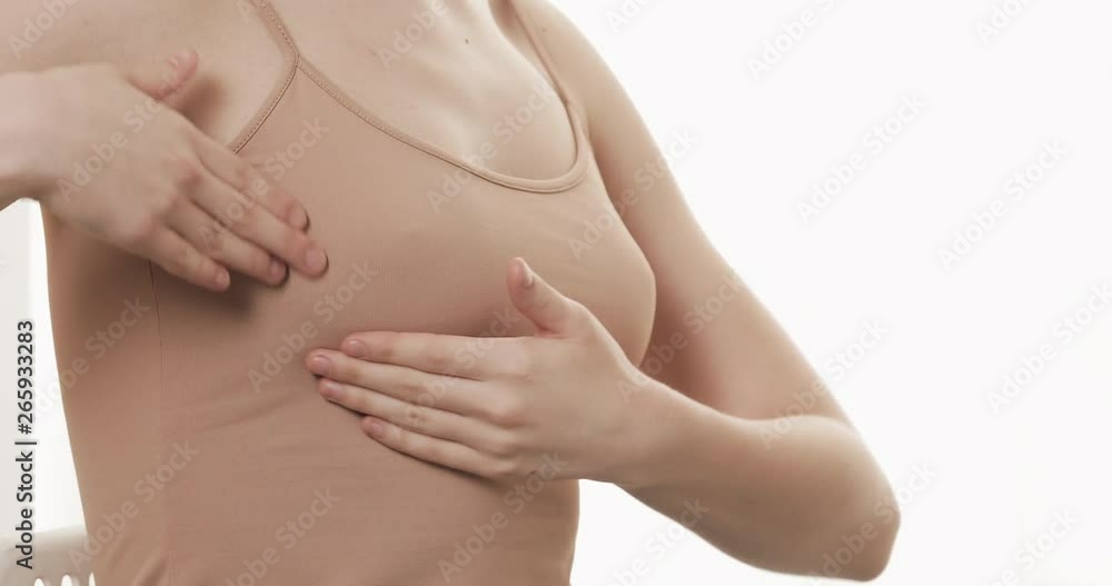 Woman checking her breast for signs of breast cancer. Healthcare and mammology concept. Close up. Woman checking her breast for signs of breast cancer. Healthcare and mammology concept. Close up.
