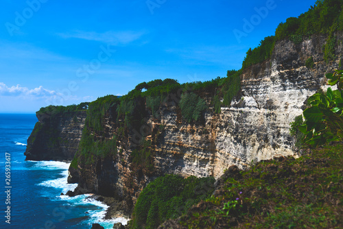 Bali seascape with huge waves and beautiful rocks. Sea beach nature, outdoor Indonesia. Island landscape. Summer holidays at ocean beach. Travel vacation in Indonesia beach. Ecological tourism.