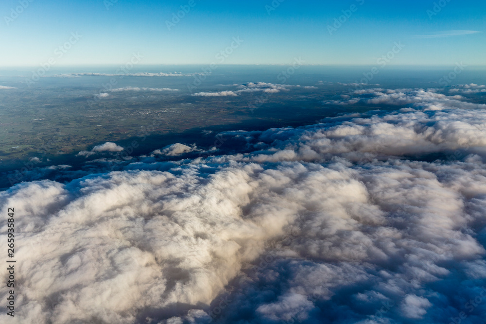 Fototapeta premium Flying above the clouds, view from the airplane, New Zealand