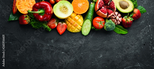 Fototapeta Naklejka Na Ścianę i Meble -  Fresh fruits, vegetables and berries. On a black background. Banner Top view. Free space for your text.