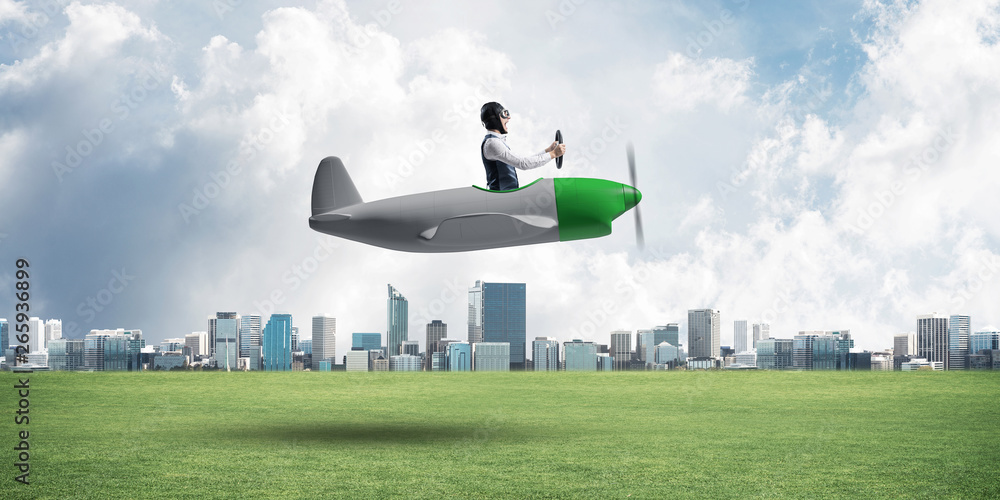 Young aviator driving small propeller plane Young aviator driving small propeller plane