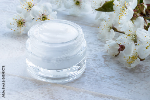 Natural face cream with spring flowers  cherries.