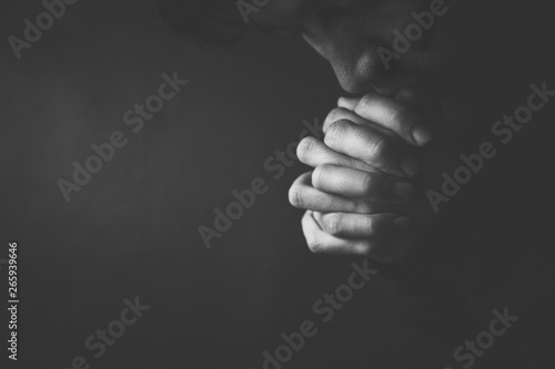 Obraz na plátně Praying Man Against Dark Background With Copy Space
