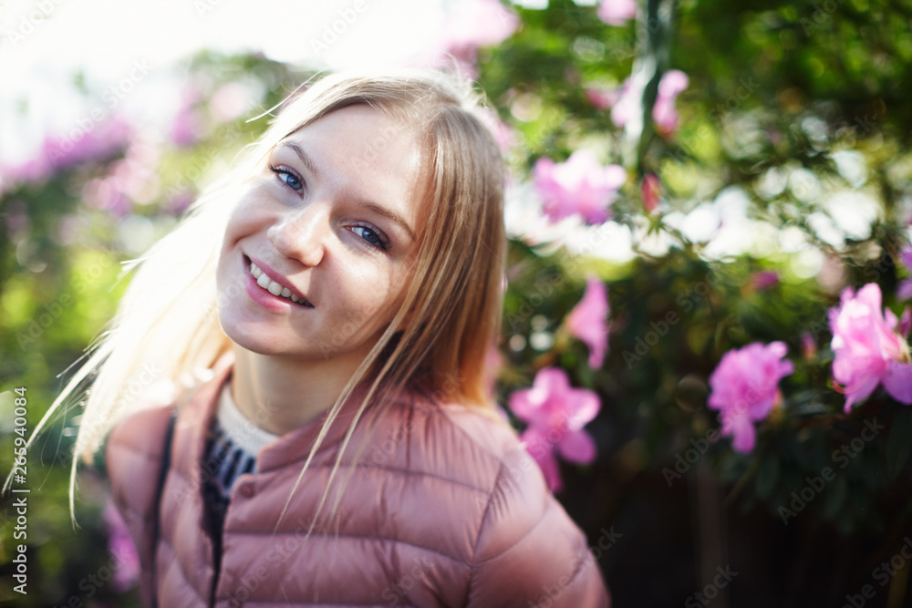 Portrait of beautiful blond girl posing in pink at garden Portrait of beautiful blond girl posing in pink at garden