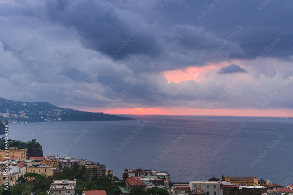 Rain clouds over beautiful sunset Sorrento Bay in Italy