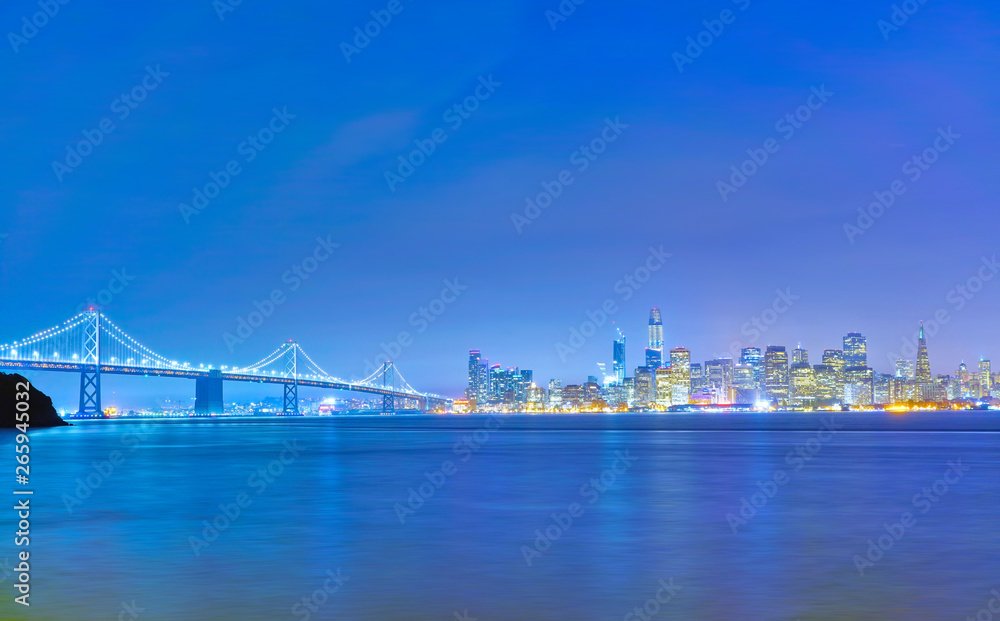 View of Bay Bridge across San Francisco Bay in San Francisco at night.