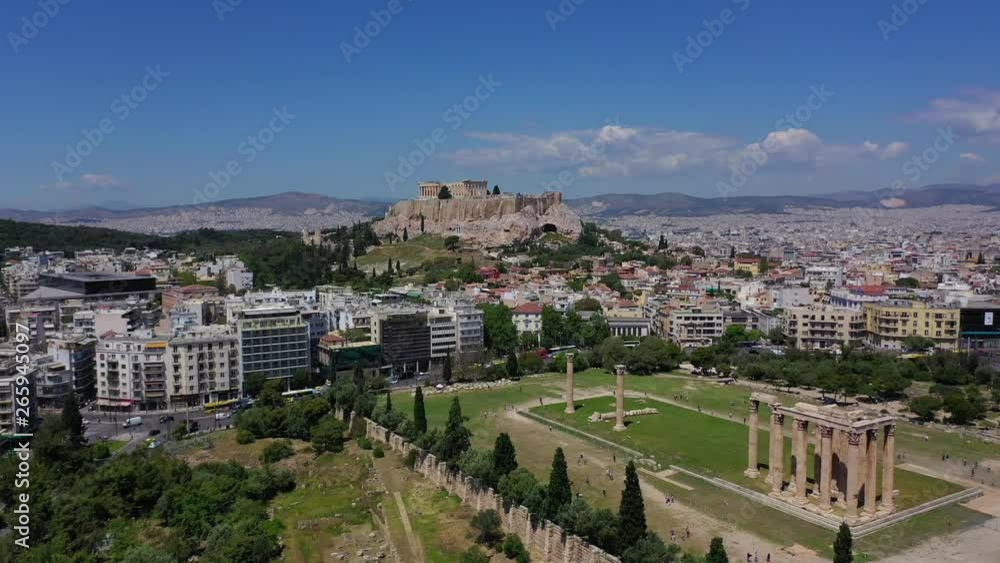 Aerial drone video of iconic Acropolis hill, the Parthenon and Anafiotika - Plaka picturesque district below, Athens historic centre, Attica, Greece