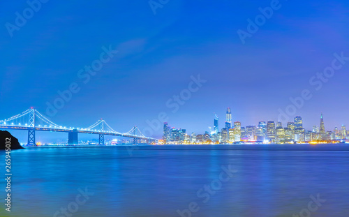 View of Bay Bridge across San Francisco Bay in San Francisco at night.