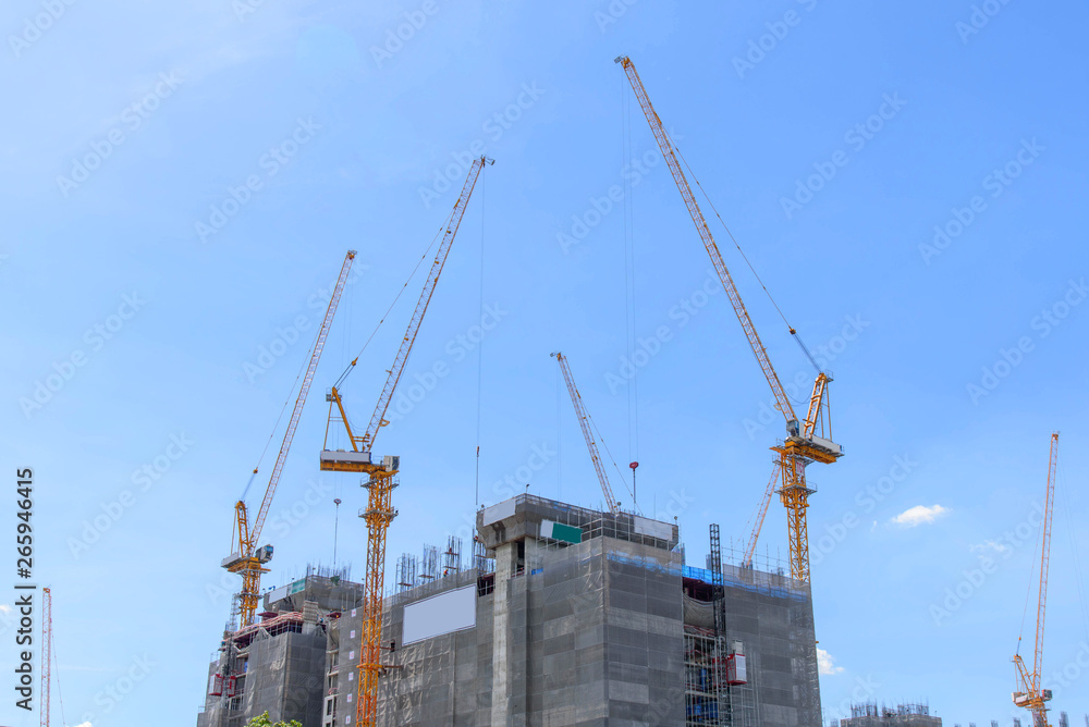 Crane on construction building in sunshine day