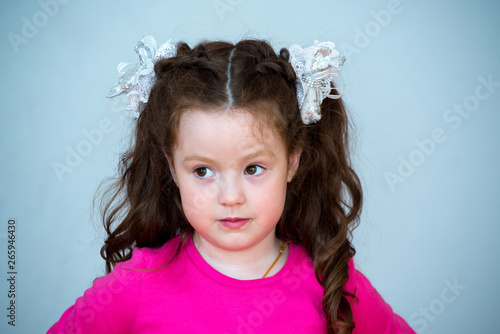 Portrait of a beautiful girl 4-5 years old. Beautiful, healthy, natural hair of dark chestnut color.