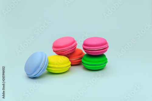 Multicolored macaroon cakes on a blue background. Imitation Cakes