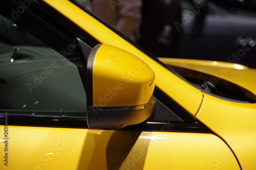 yellow modern SUV car side view mirror and door windshield A pillar detail © Steven