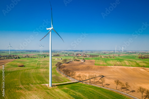 Aerial view of big wind turbines in spring