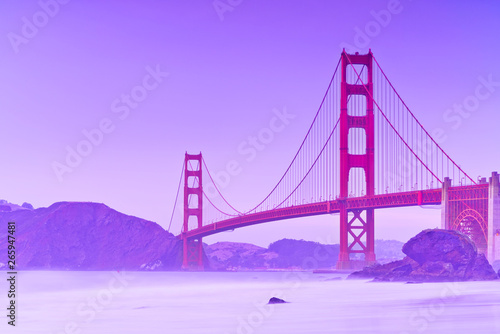 View of Golden Gate Bridge from Marshall's Beach in San Francisco at twilight.