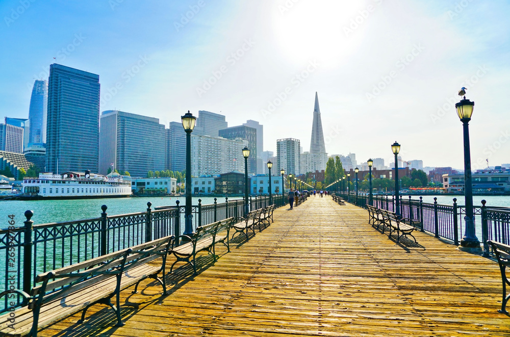 View of the boardwalk at Pier 7 with the skyline of San Francisco in the background.