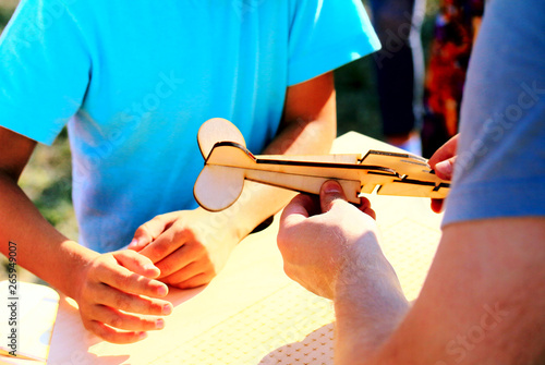 Teacher shows the student how to build a model aircraft