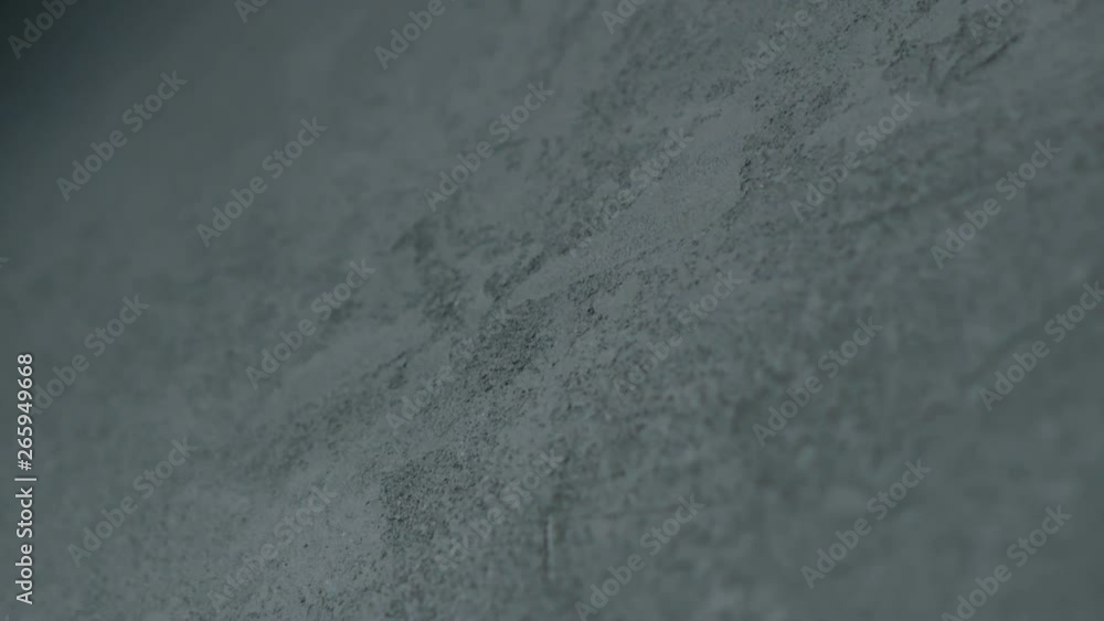 Slow motion shot of decorative dark concrete surface, shot handheld Slow motion shot of decorative dark concrete surface, shot handheld