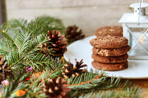 Christmas decorations - oat biscuits for Santa Claus and branches of coniferous trees