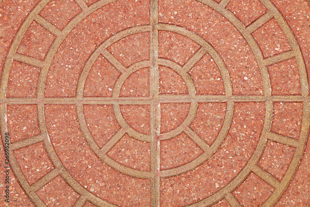 Stone texture. Background of red stone on the street of the city, in round patterns.