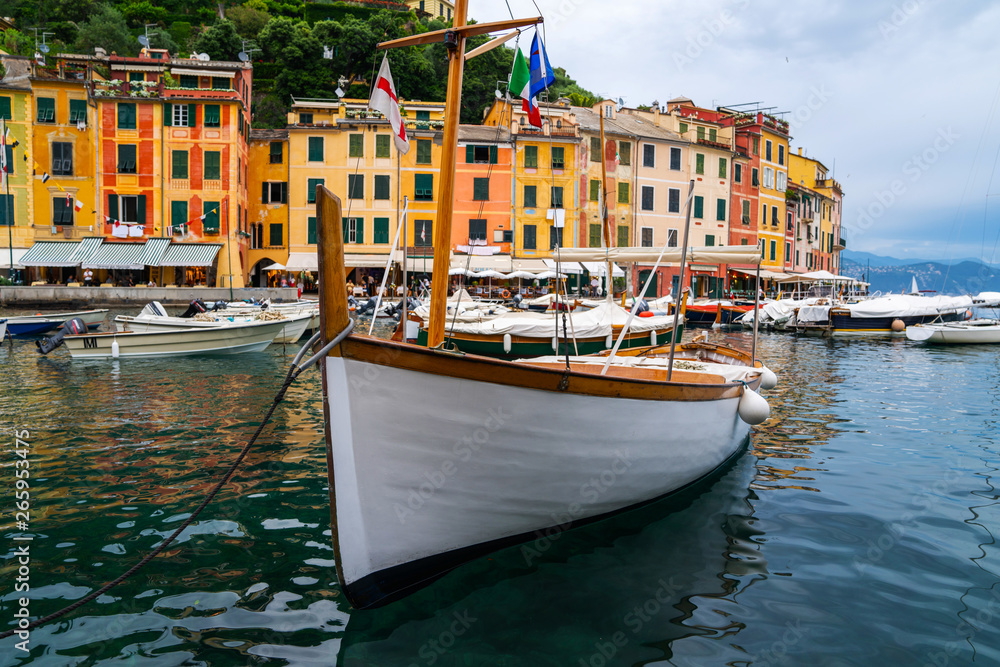 The beautiful Portofino panorama with colorfull houses, luxury boats and yacht in little bay harbor. Liguria, Italy. Postcard of Portofino. Travel and vacation concept.