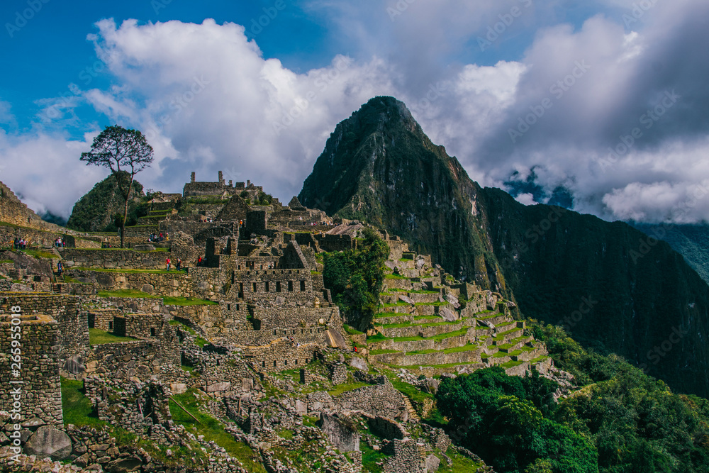 Machu Picchu, the lost city of the Incas on a cloudy day. Machu Picchu is one of the new Seven Wonder of the Wonders near Cusco, Peru.