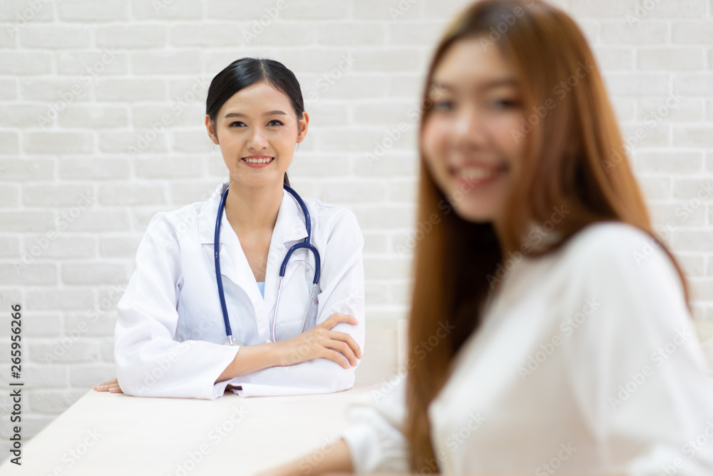 Female doctor talking to patient.Doctor and patient discussing something while sitting at the table . Medicine and health care concept. Doctor and patient Female doctor talking to patient.Doctor and patient discussing something while sitting at the table . Medicine and health care concept. Doctor and patient