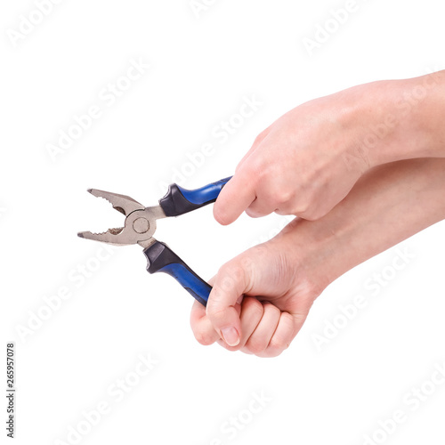 Pliers in the hand of a girl. Symbol of hard work, feminism and labor day. Isolate on white background.