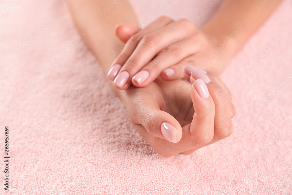 Closeup view of beautiful female hands on towel, space for text. Spa treatment