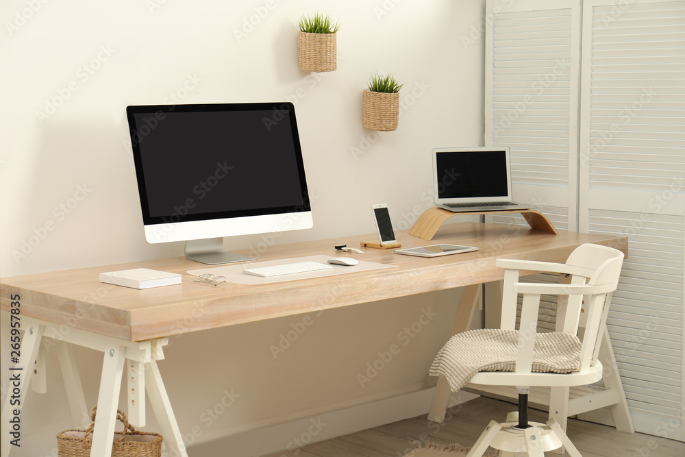 Fototapeta premium Stylish workplace interior with modern computer on table. Mockup for design
