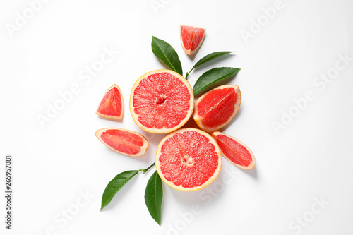 Fotografering Grapefruits and leaves on white background, top view