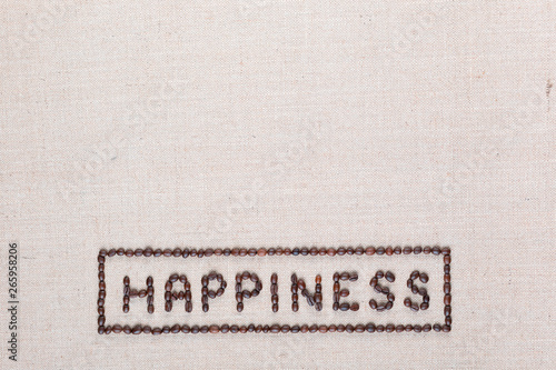 Happiness sign from coffee beans on linea texture, aligned bottom center.
