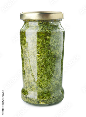 Jar of tasty pesto sauce isolated on white