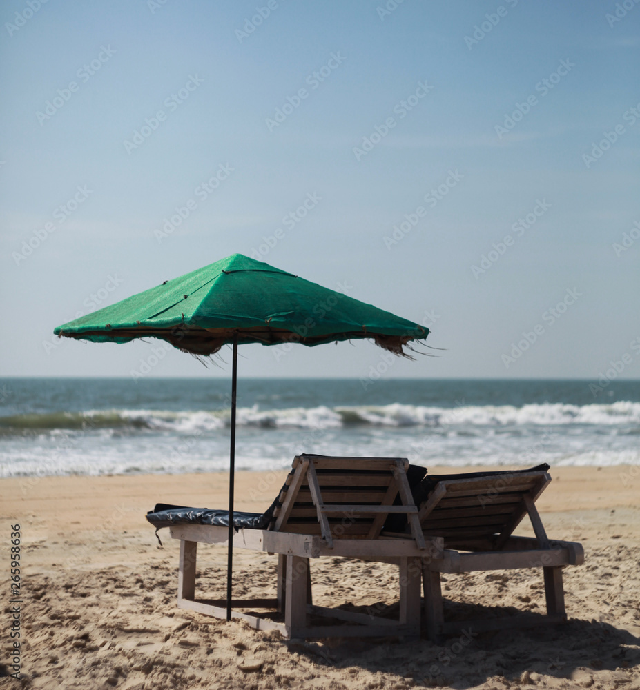 Umbrella and sun beds on the beach in goa Umbrella and sun beds on the beach in goa