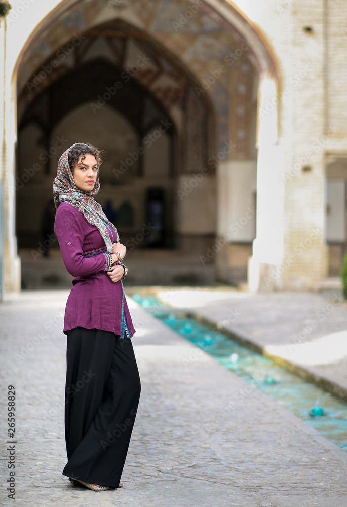 Fototapeta premium iranian lady in Fin gardens in Kashan, Iran