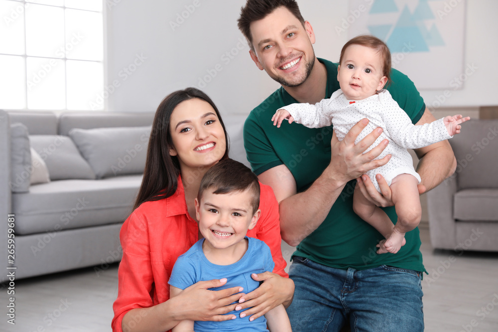 Portrait of happy parents and their cute children at home. Family time Portrait of happy parents and their cute children at home. Family time