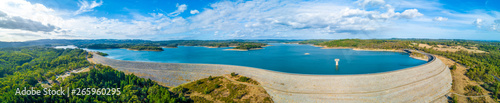 Wide aerial panorama of Cardinia Reservoir lake and dam wall surrounded by forest
