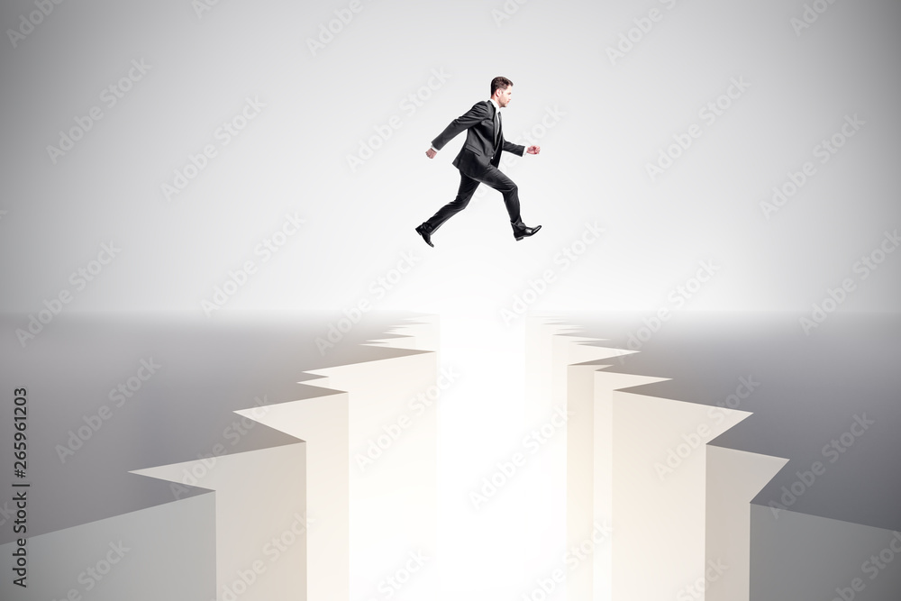 Businessman jumping over gap Businessman jumping over gap